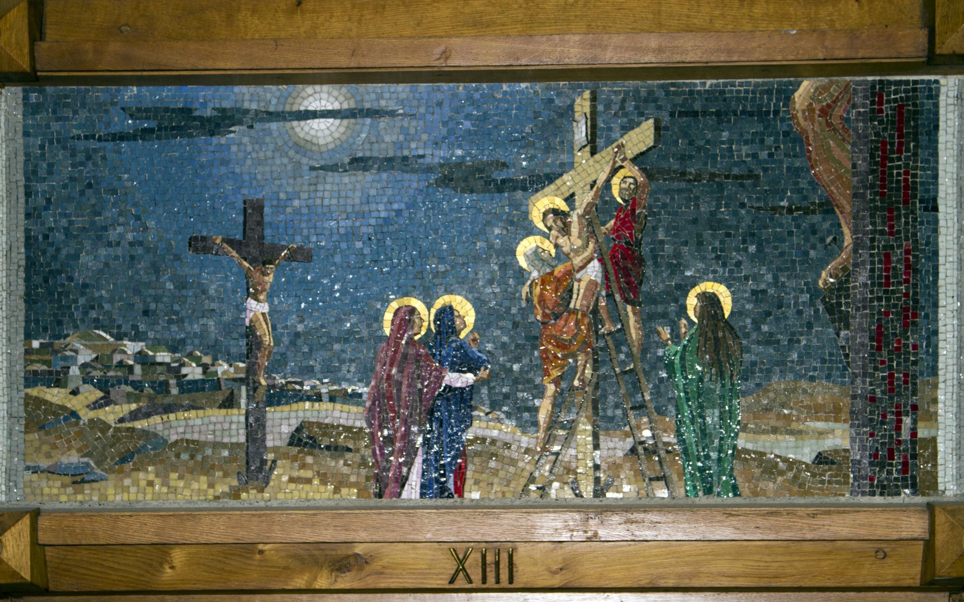 A mosaic painting of jesus being nailed to a cross.