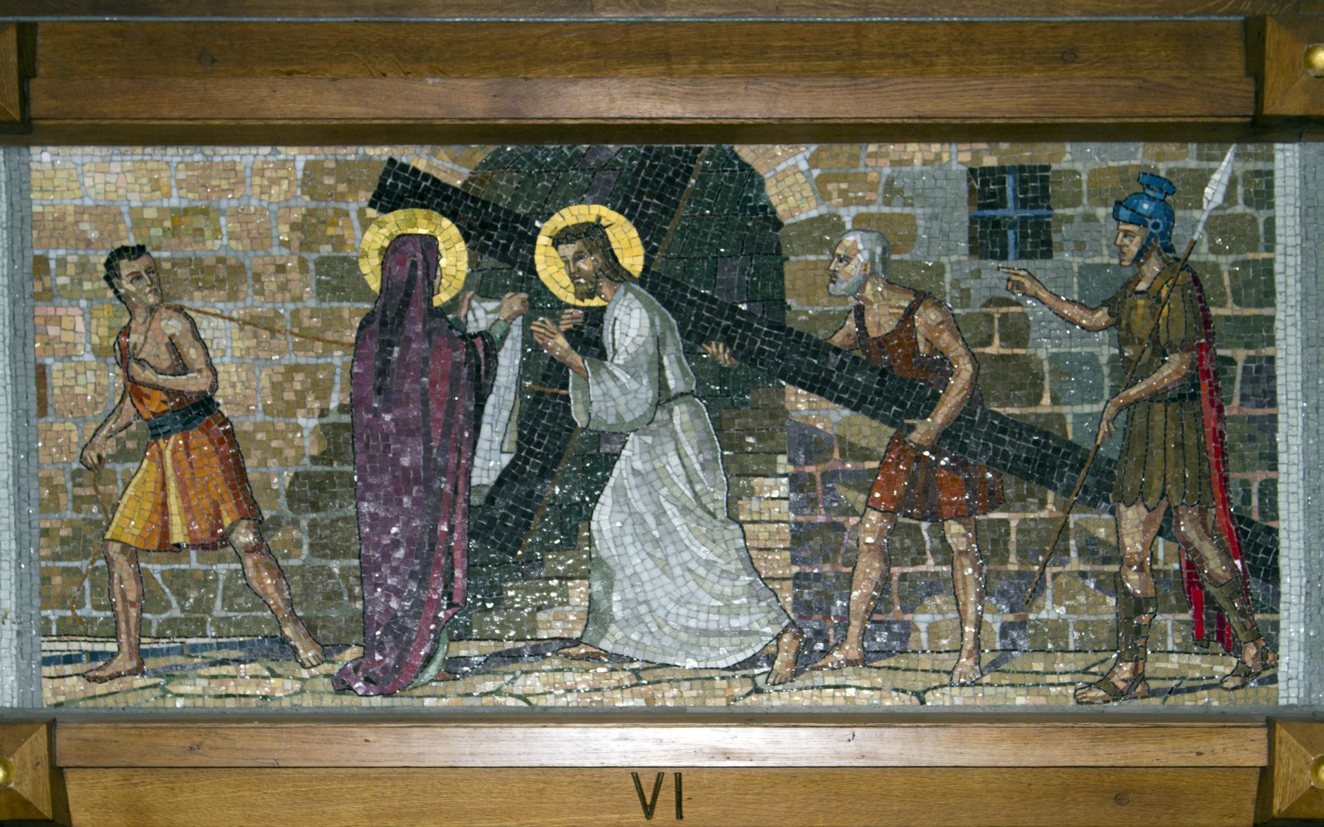 A mosaic painting of jesus carrying the cross