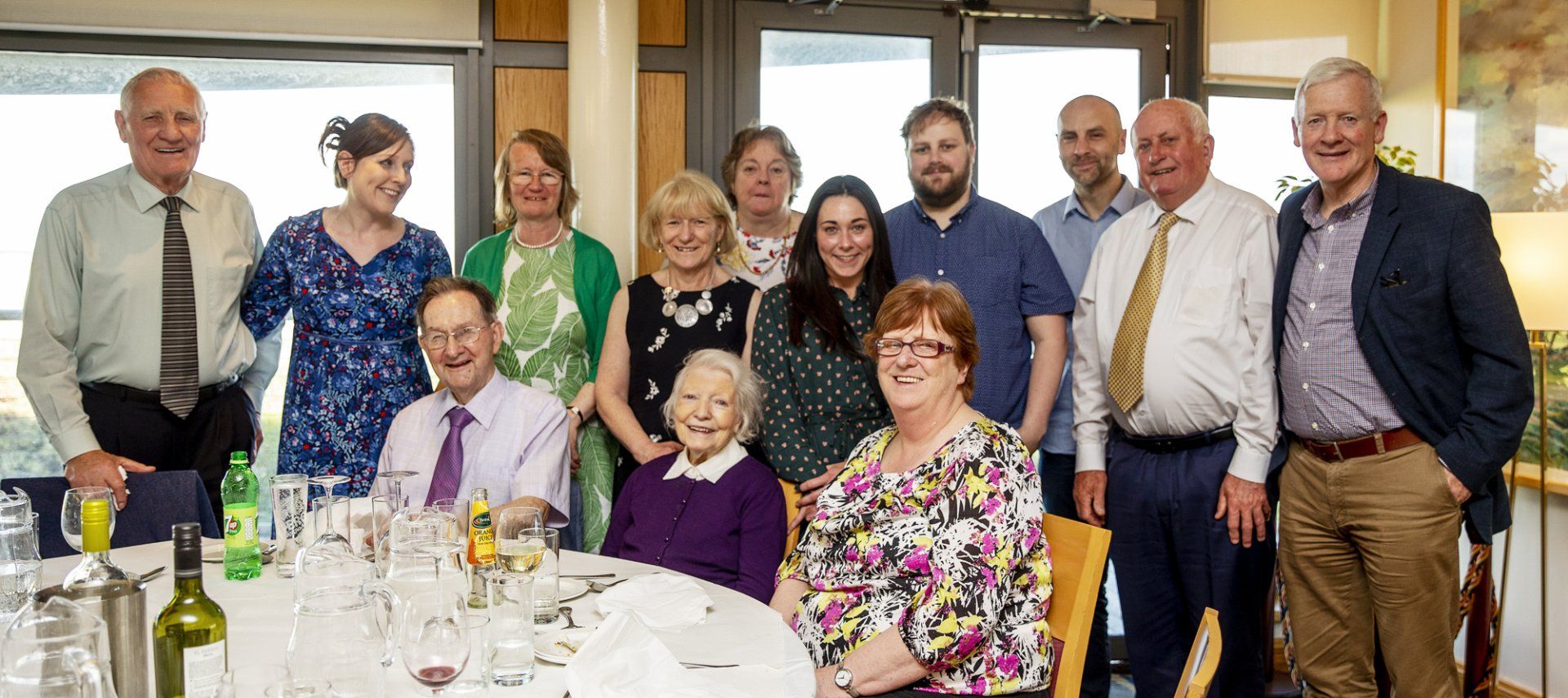 A group of people are posing for a picture in front of a table.