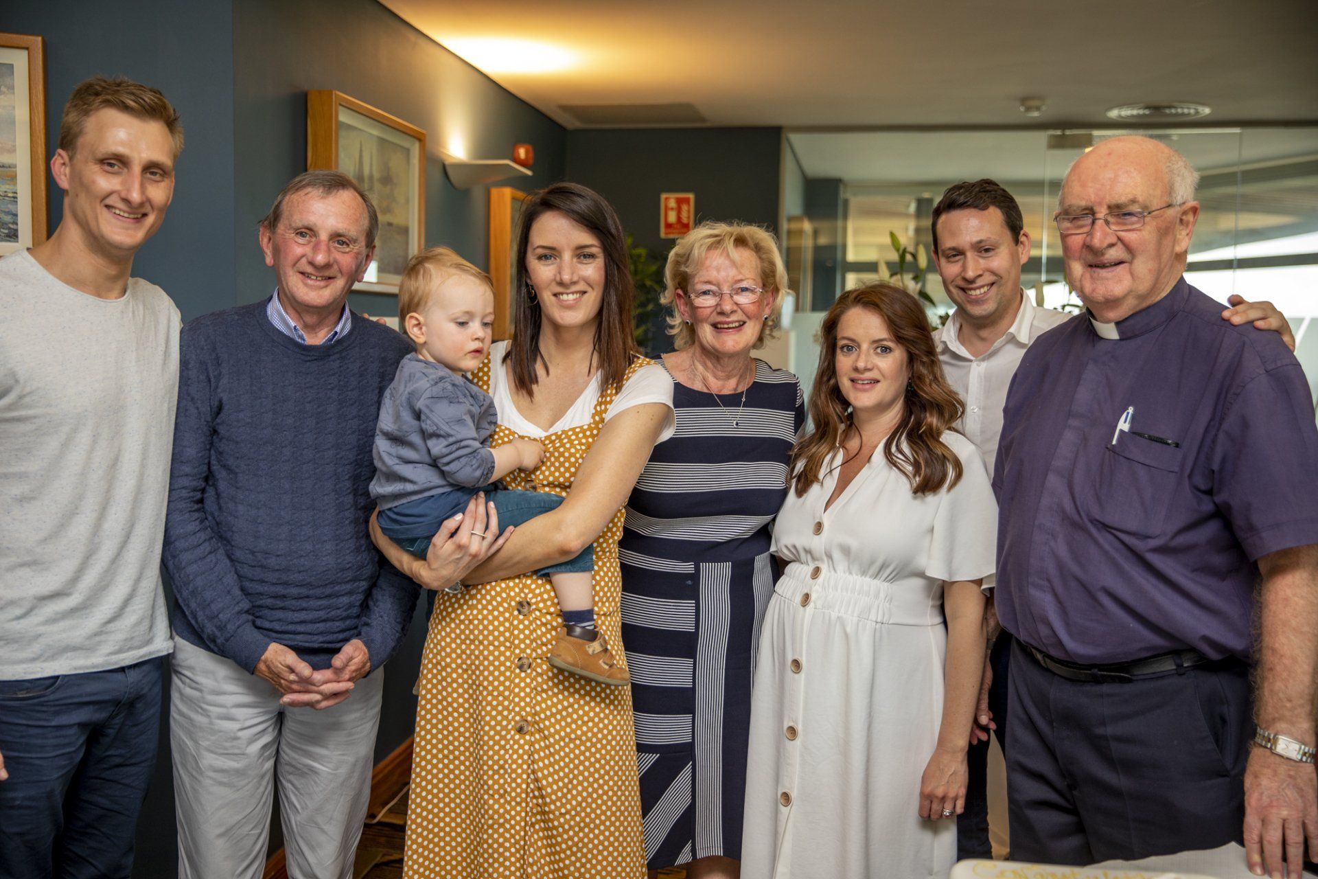 A group of people are posing for a picture together in a room.