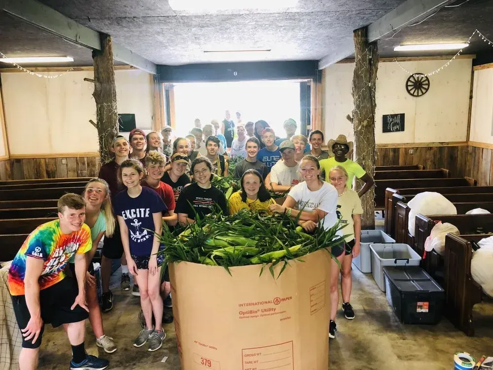 By Faith Farm Volunteers with corn harvest.