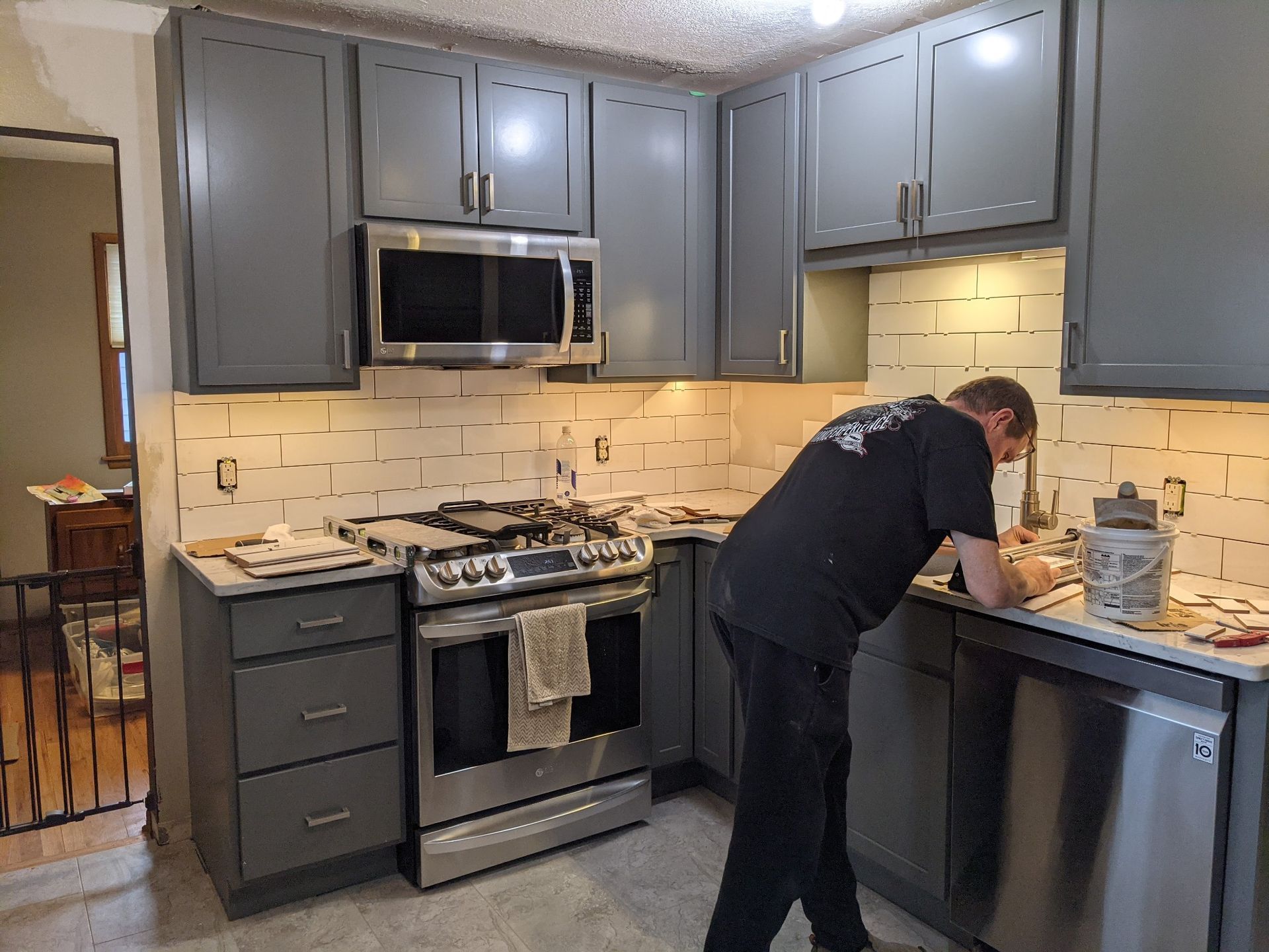 Cary Thompson owner CTC Renovation, is working in a outdated kitchen.