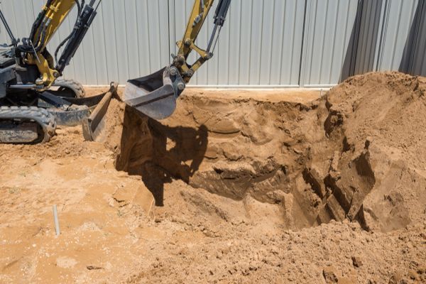 A bulldozer is digging a hole in the ground.