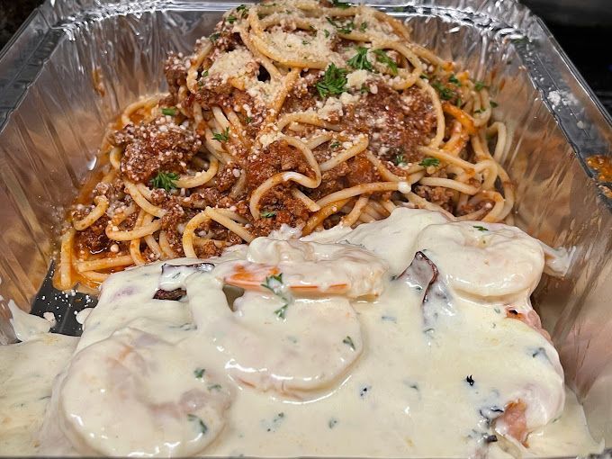 A Tray Of Spaghetti And Shrimp With Sauce On Top — Michelangelo's Pizza & Pasta in Kirwan, QLD