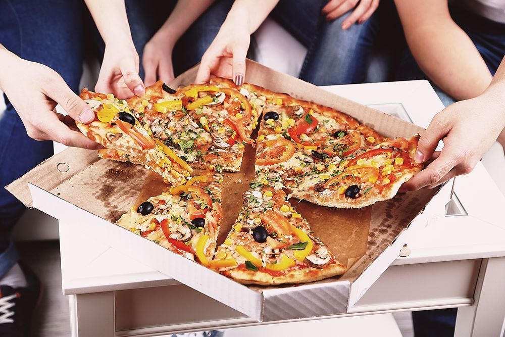 A Group of People Are Taking Slices of Pizza Out of a Box — Michelangelos Pizza & Pasta in  Kirwan, QLD