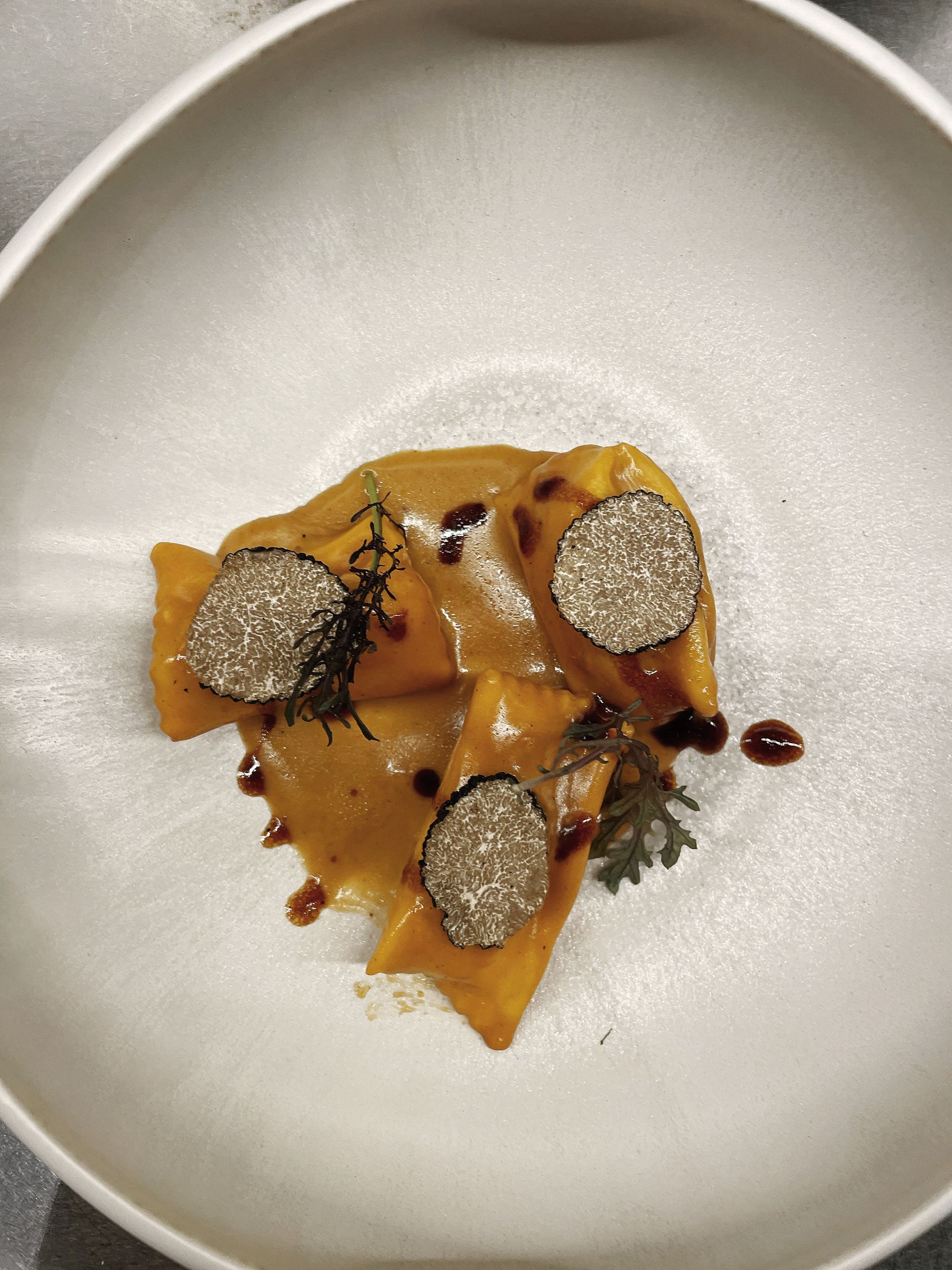 A close up of a plate of food with sauce on it