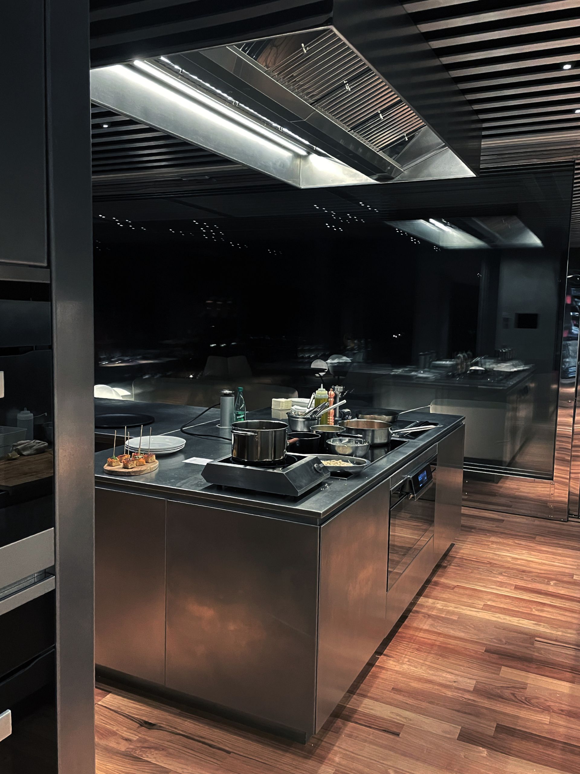 A kitchen with stainless steel appliances and wooden floors