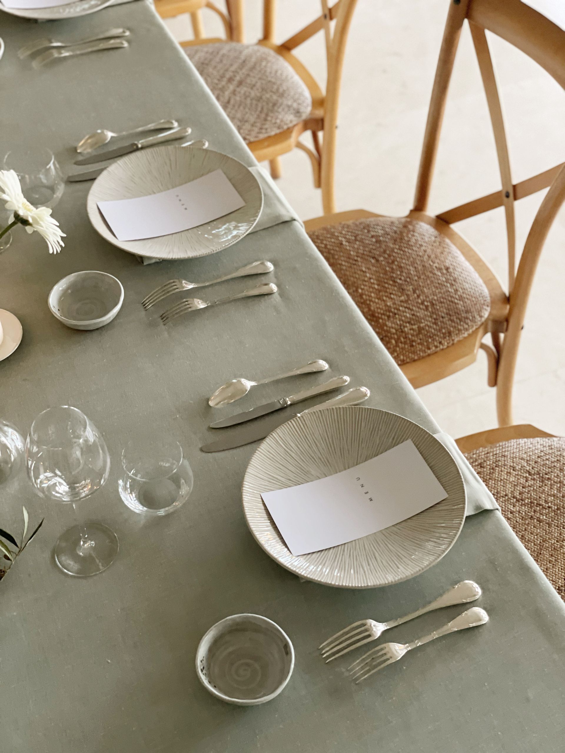 A long table with plates and silverware on it