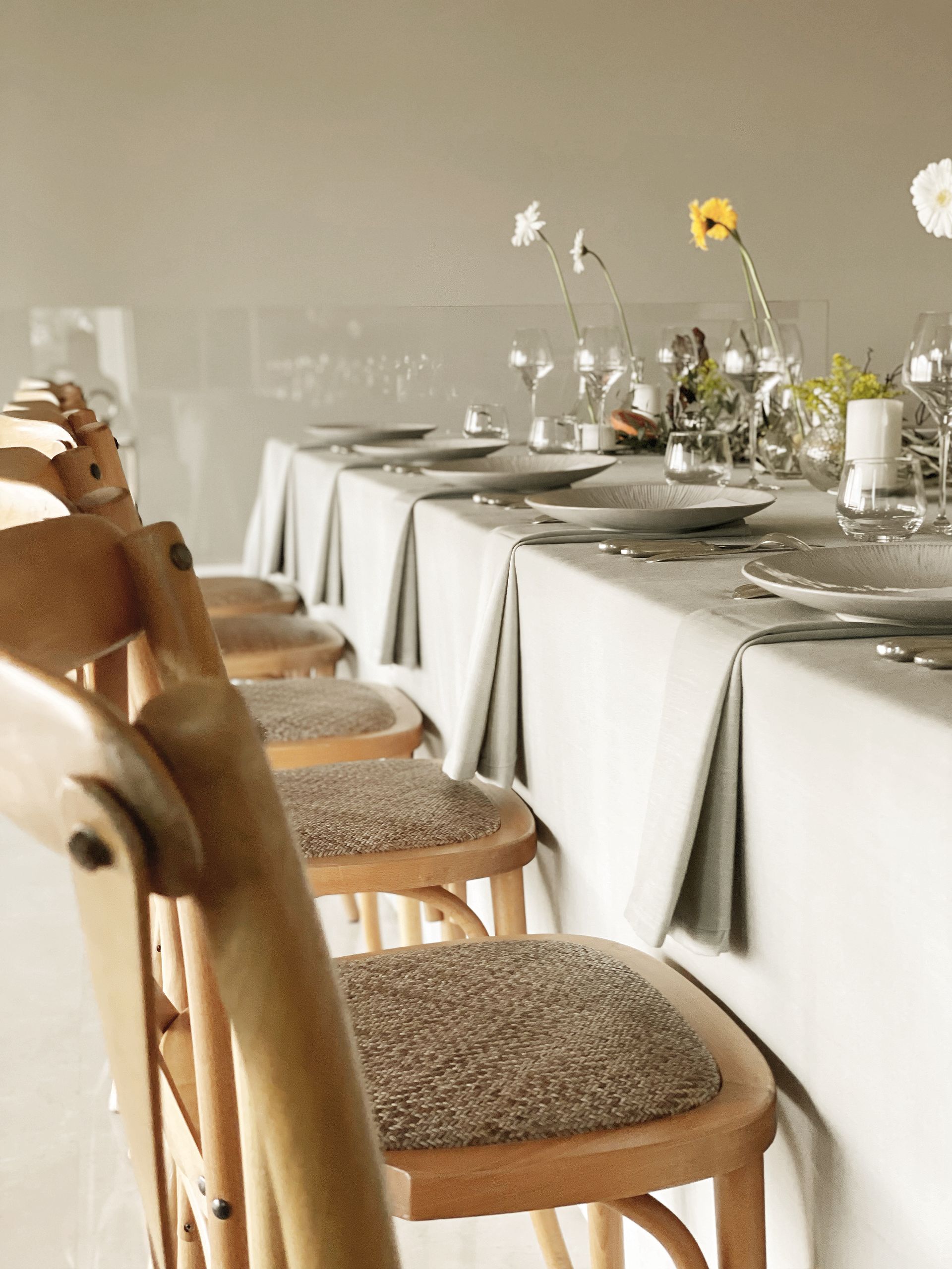 A row of wooden chairs sitting in front of a long table