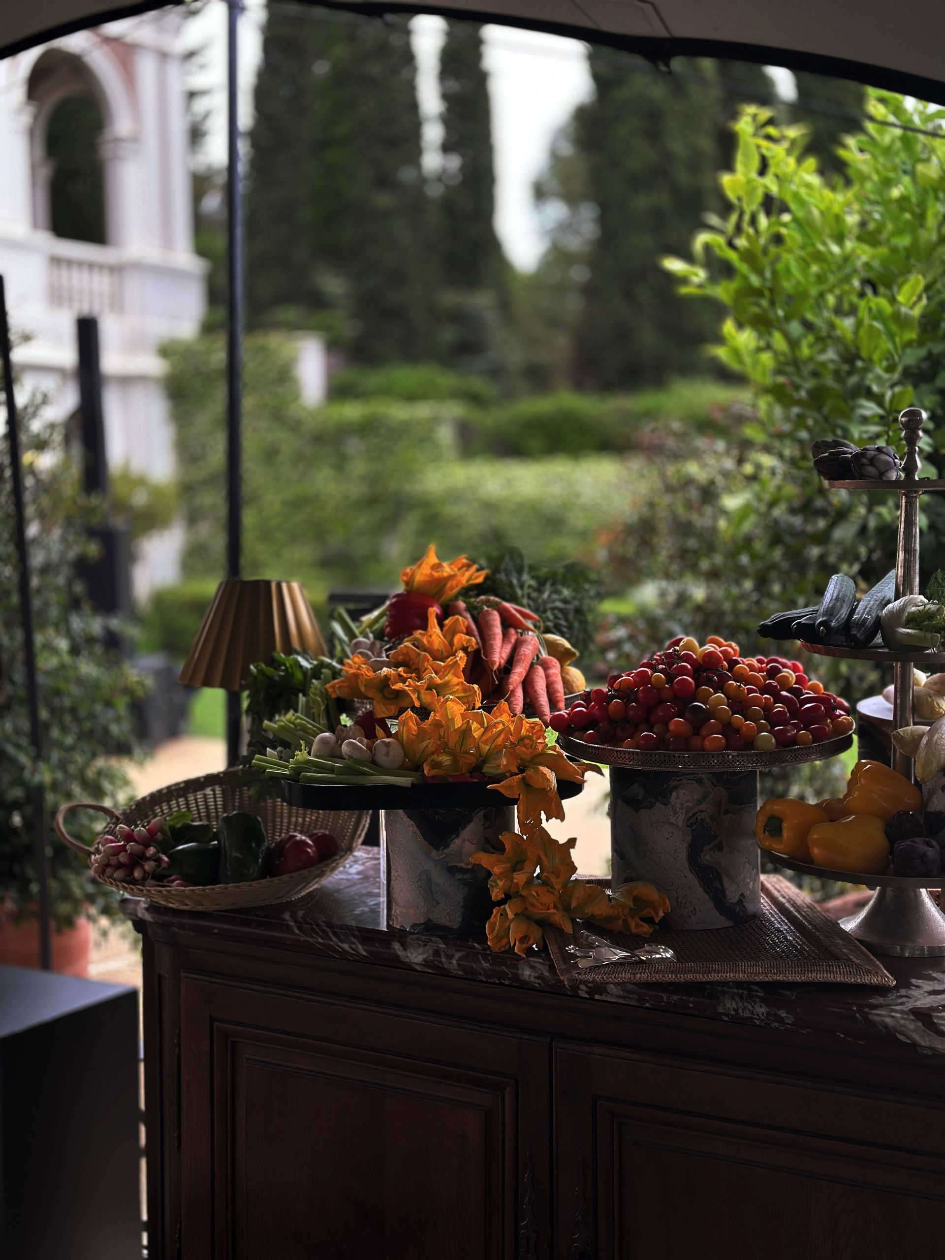 A table topped with bowls of fruit and flowers.