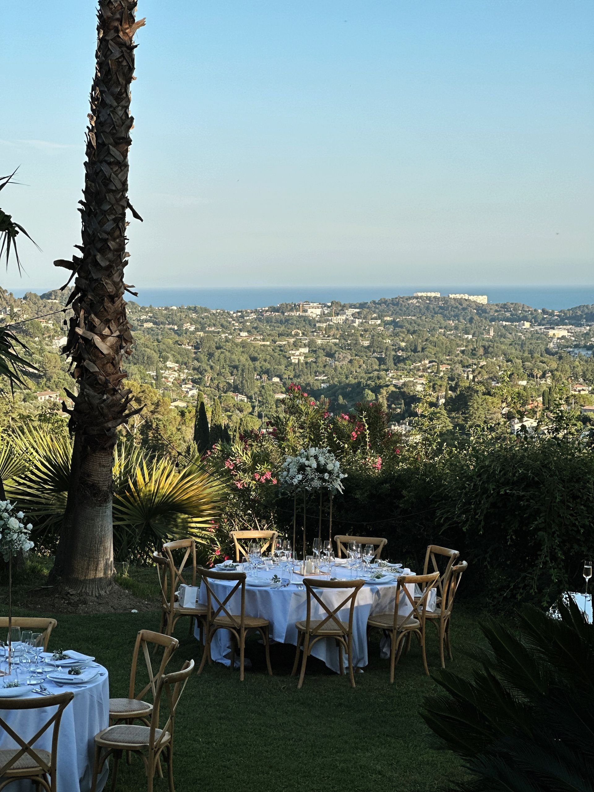 Tables and chairs set up in a garden with a view