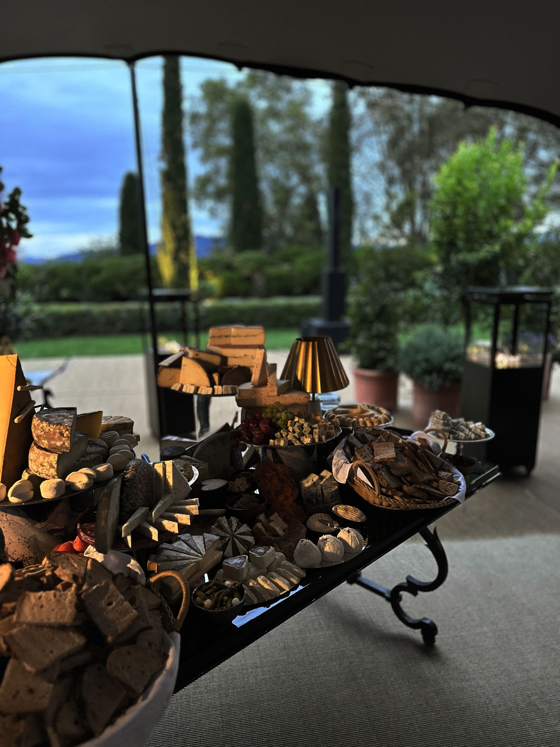 A table with a lot of food on it under a tent