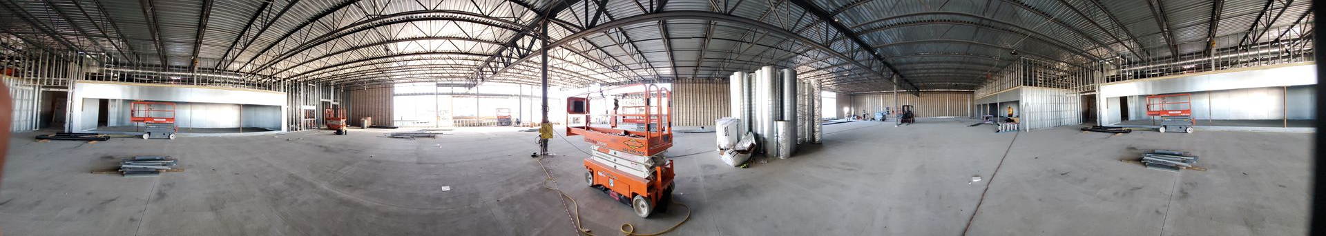 An interior view of a train station with visible tracks and a sign. The scene is somewhat distorted.