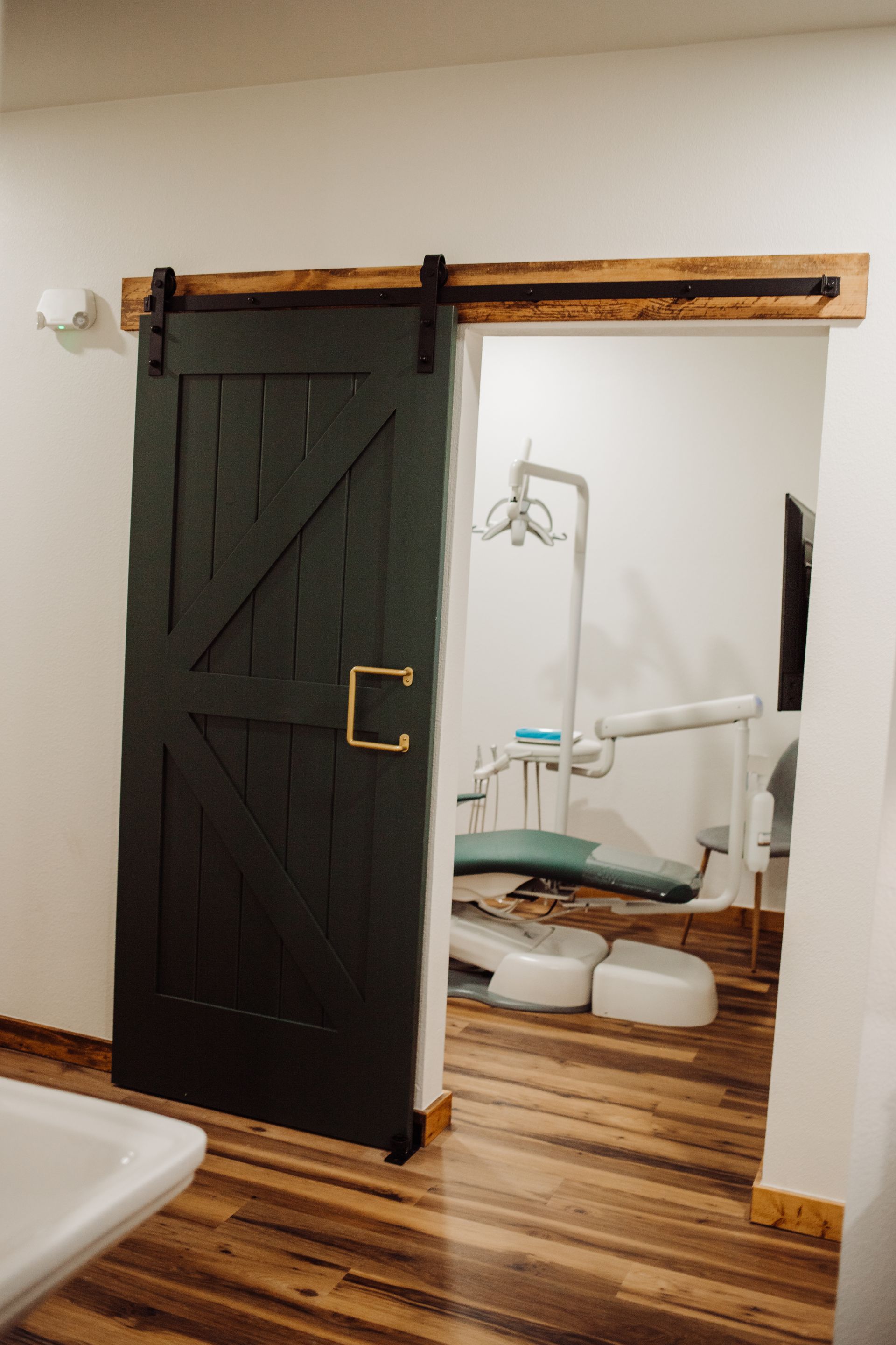 Two dental staff with a child in a dental chair. Office setting.