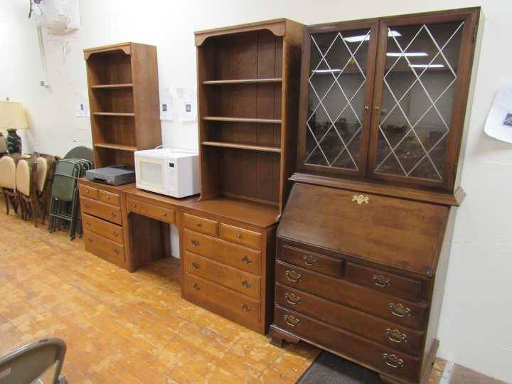 Wooden furniture set with bookcases, desk, and dressers displayed in a room