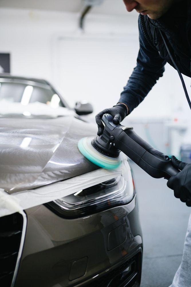 Person Polishing a Gray Car Headlight With a Power Buffer — Bob Kolln Automotive In Charmhaven, NSW