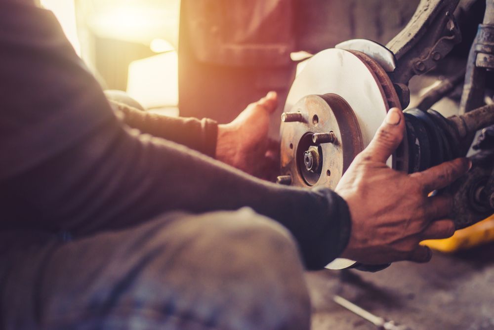 Mechanic Installing a Brake Rotor on a Vehicle, Workshop Setting — Bob Kolln Automotive In Warnervale, NSW