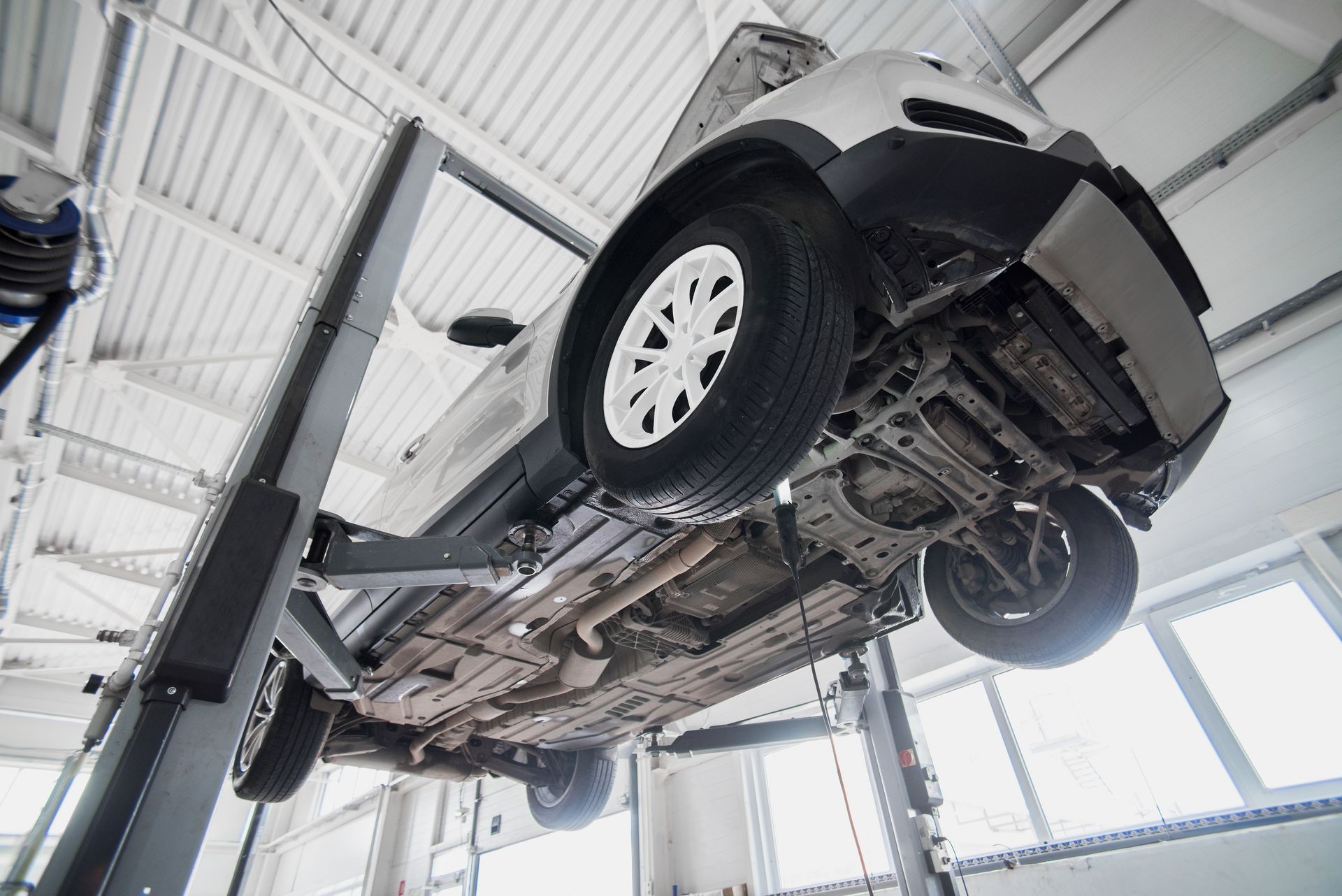Car Raised on a Lift in a Repair Shop, Showing Underside — Bob Kolln Automotive In Toukley, NSW