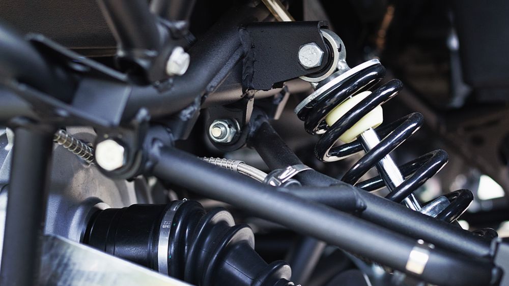 Black Vehicle Suspension System With a Shock Absorber and Coiled Spring — Bob Kolln Automotive In Charmhaven, NSW