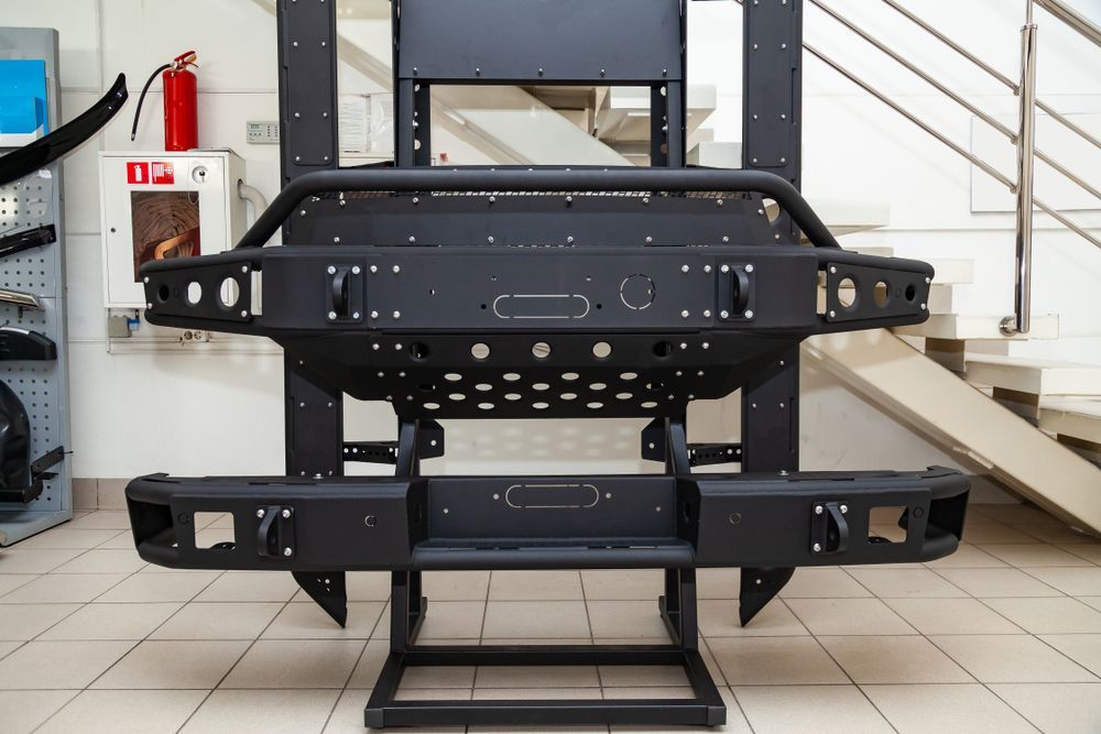 Black Off-road Vehicle Bumpers Displayed on a Stand Inside a Building — Bob Kolln Automotive In Woongarrah, NSW