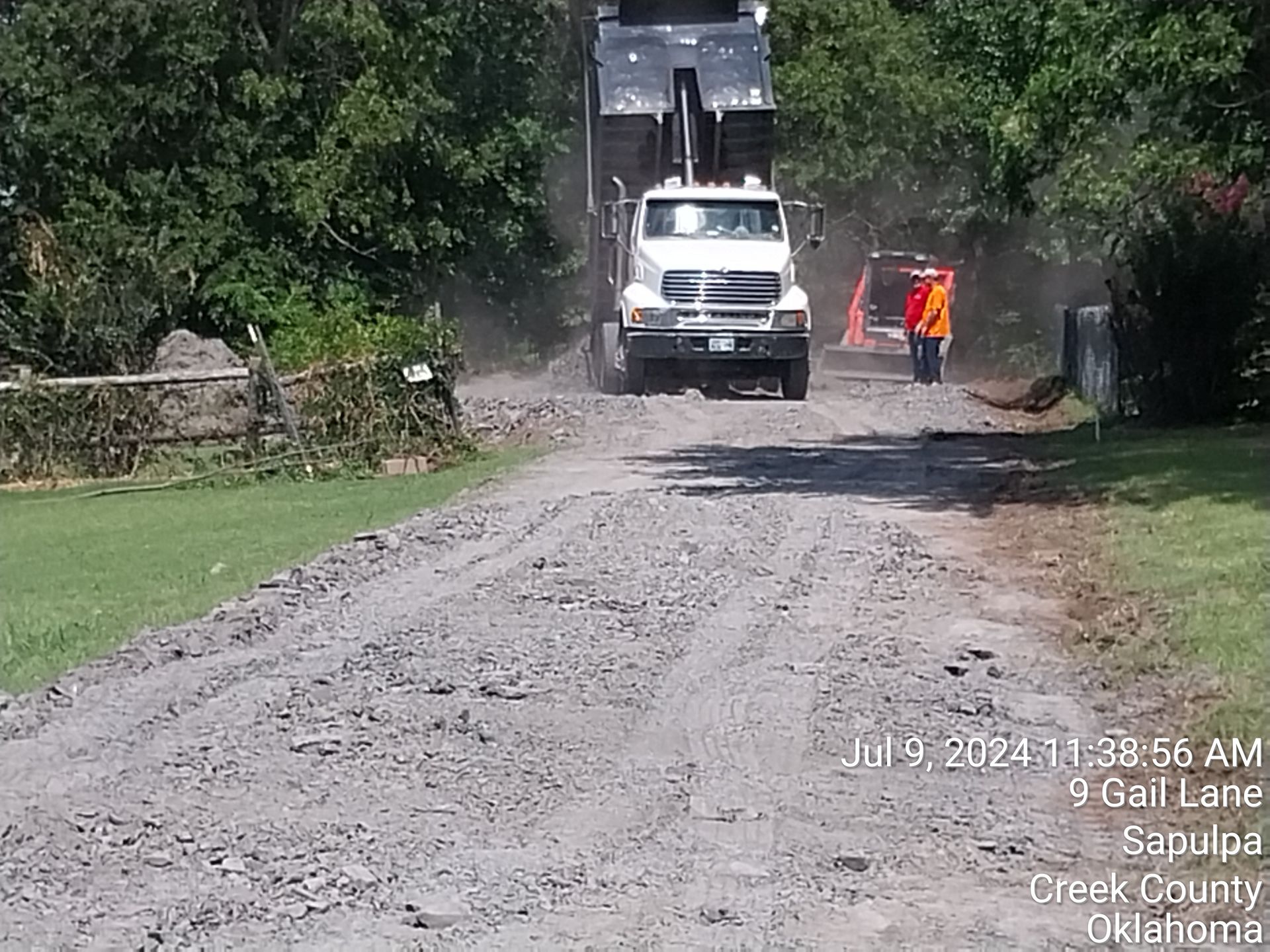 A large house with a concrete driveway leading to it