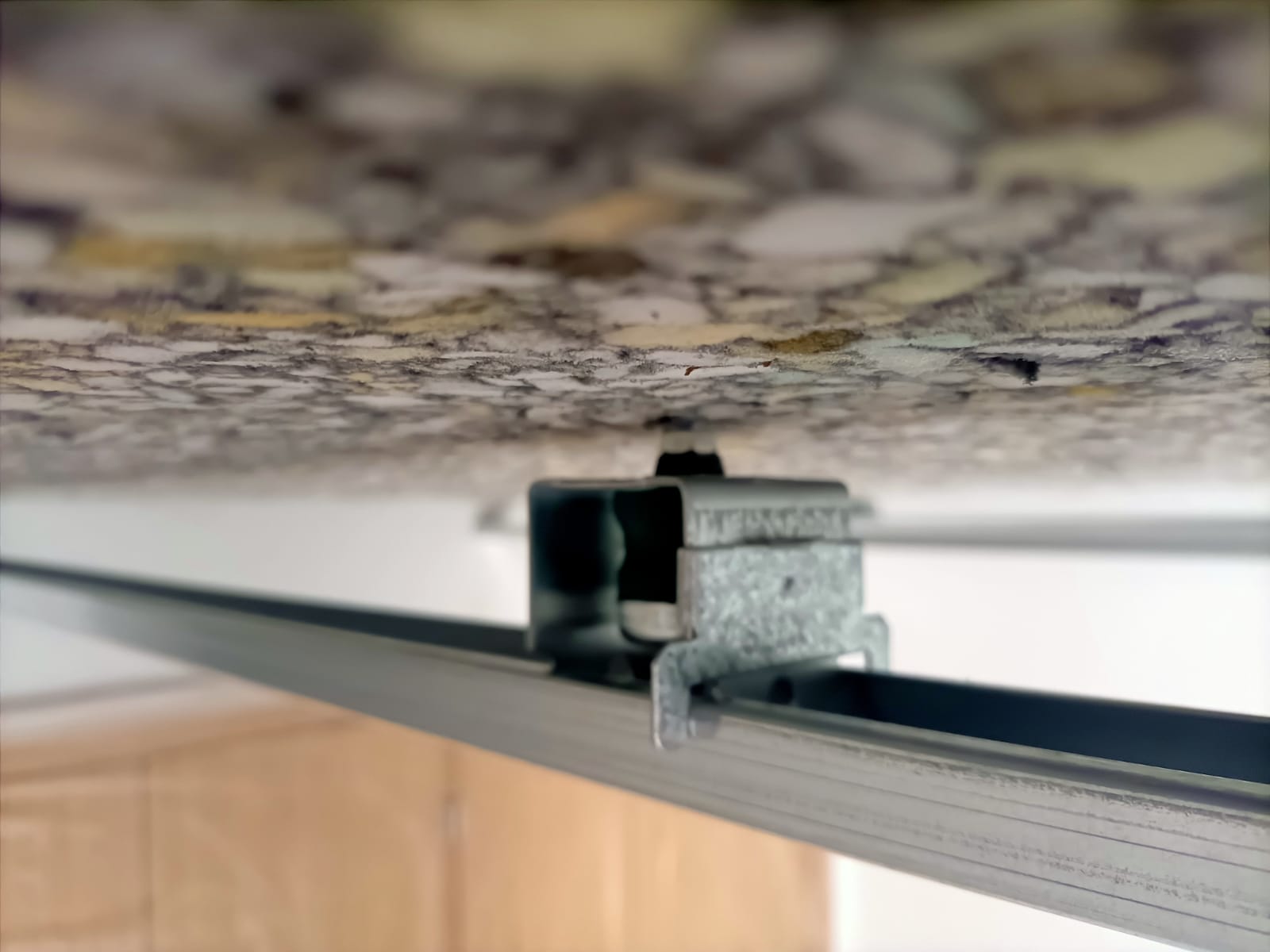 Un primer plano de una viga de metal que cuelga del techo.