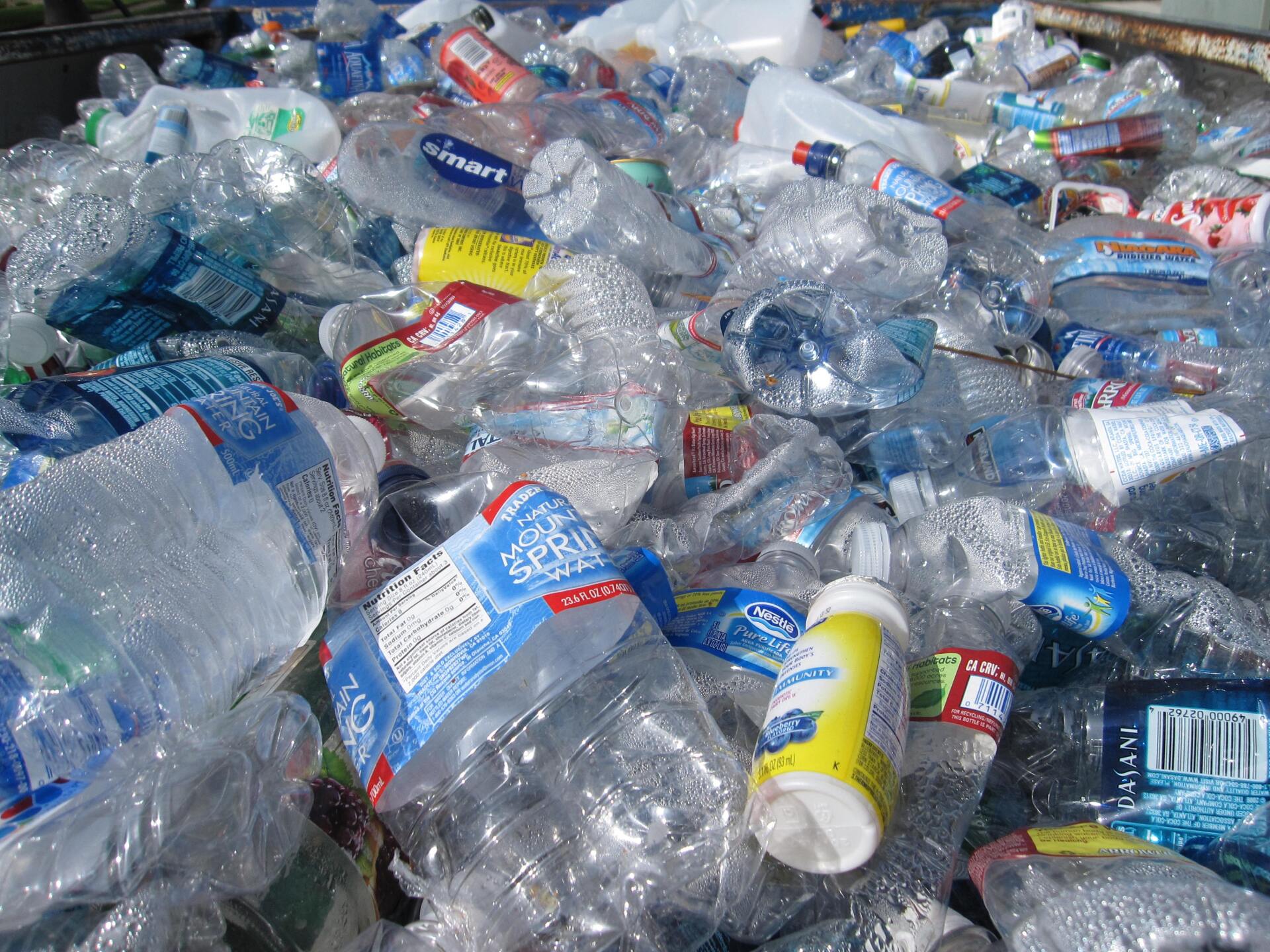 A pile of plastic bottles including aqua smart