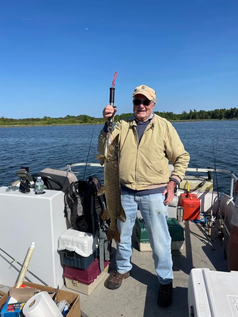 A living room with a spiral staircase and a fireplace