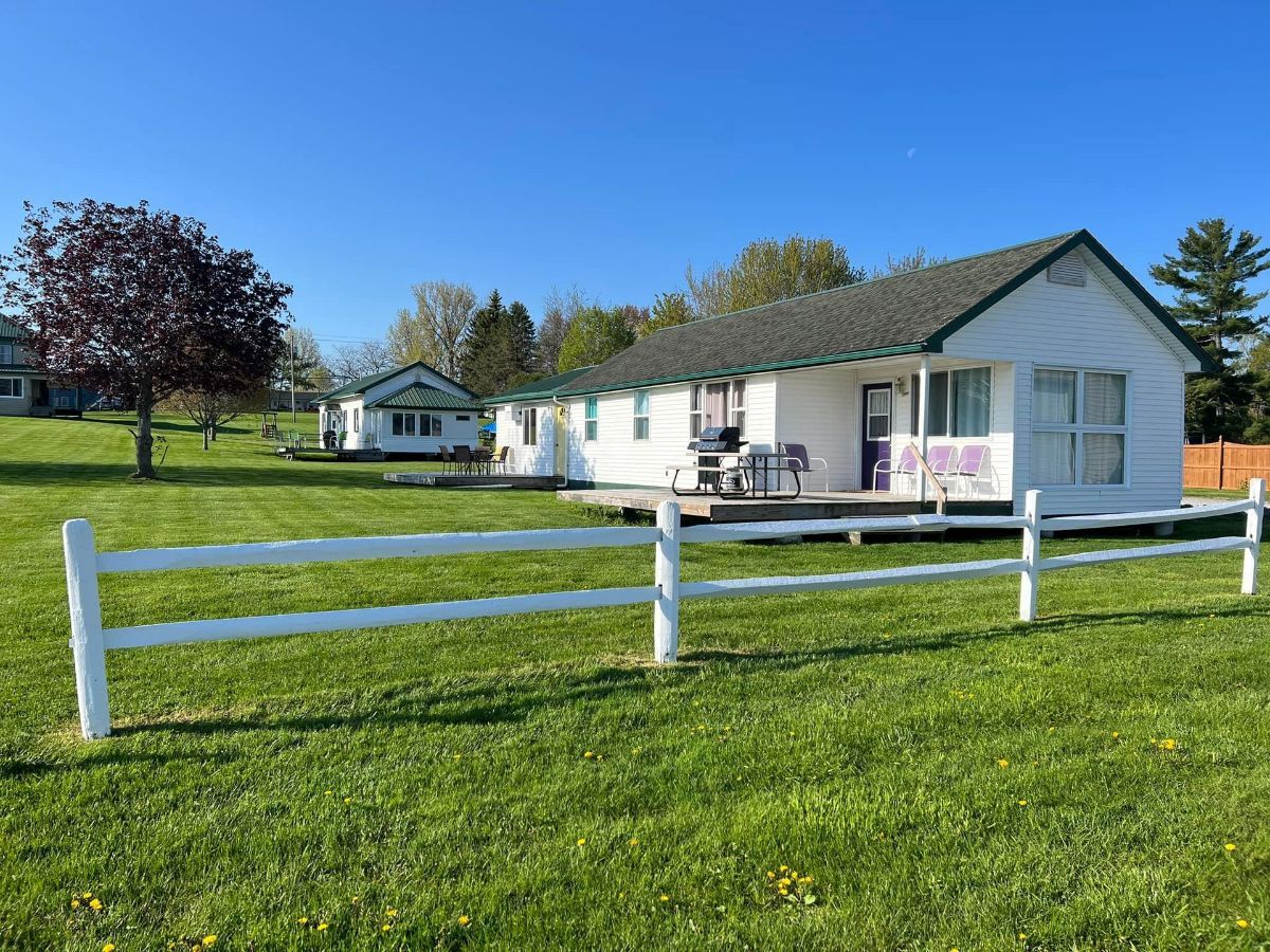A white house with a white fence in front of it