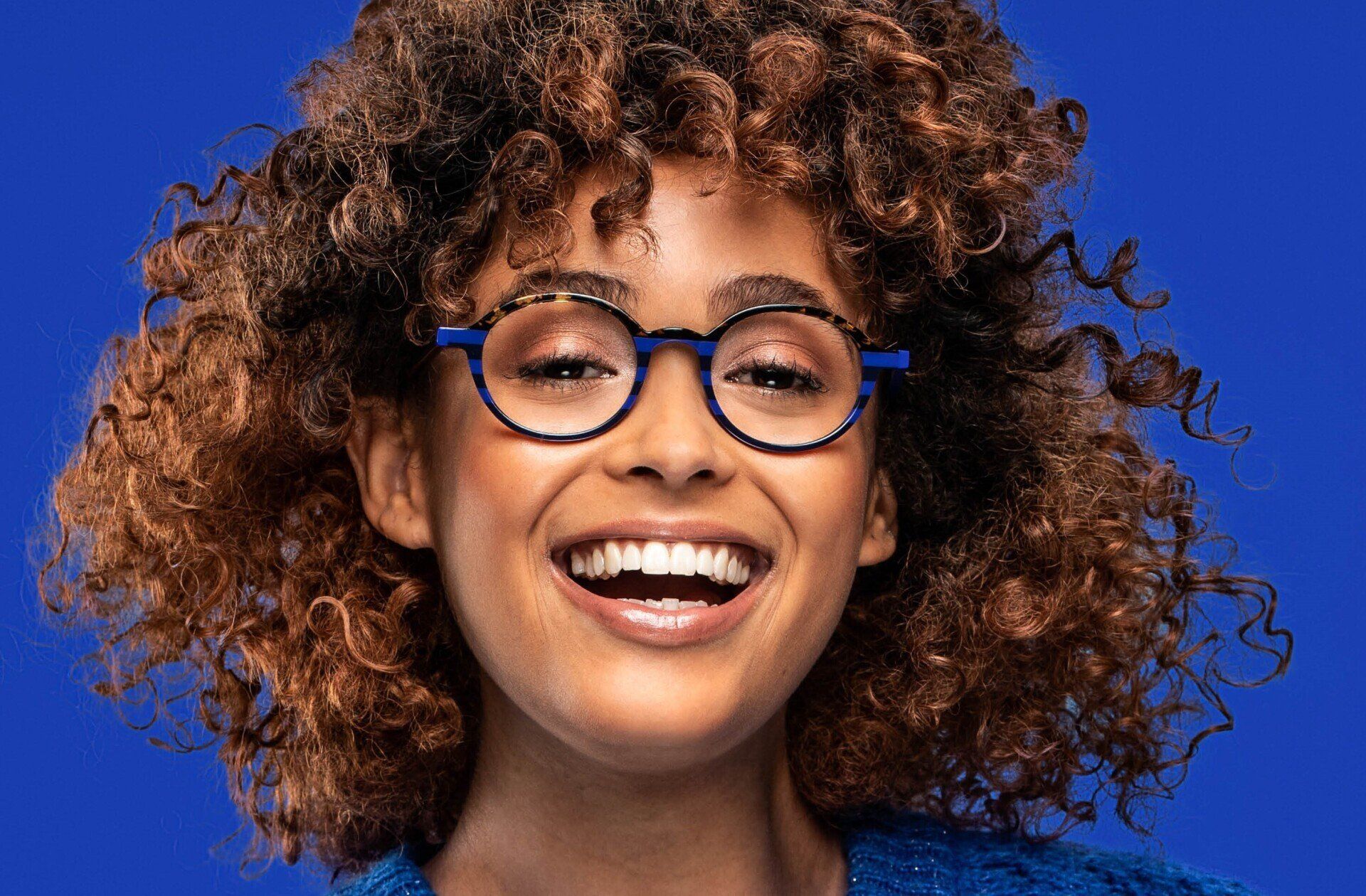 person smiling wearing glasses