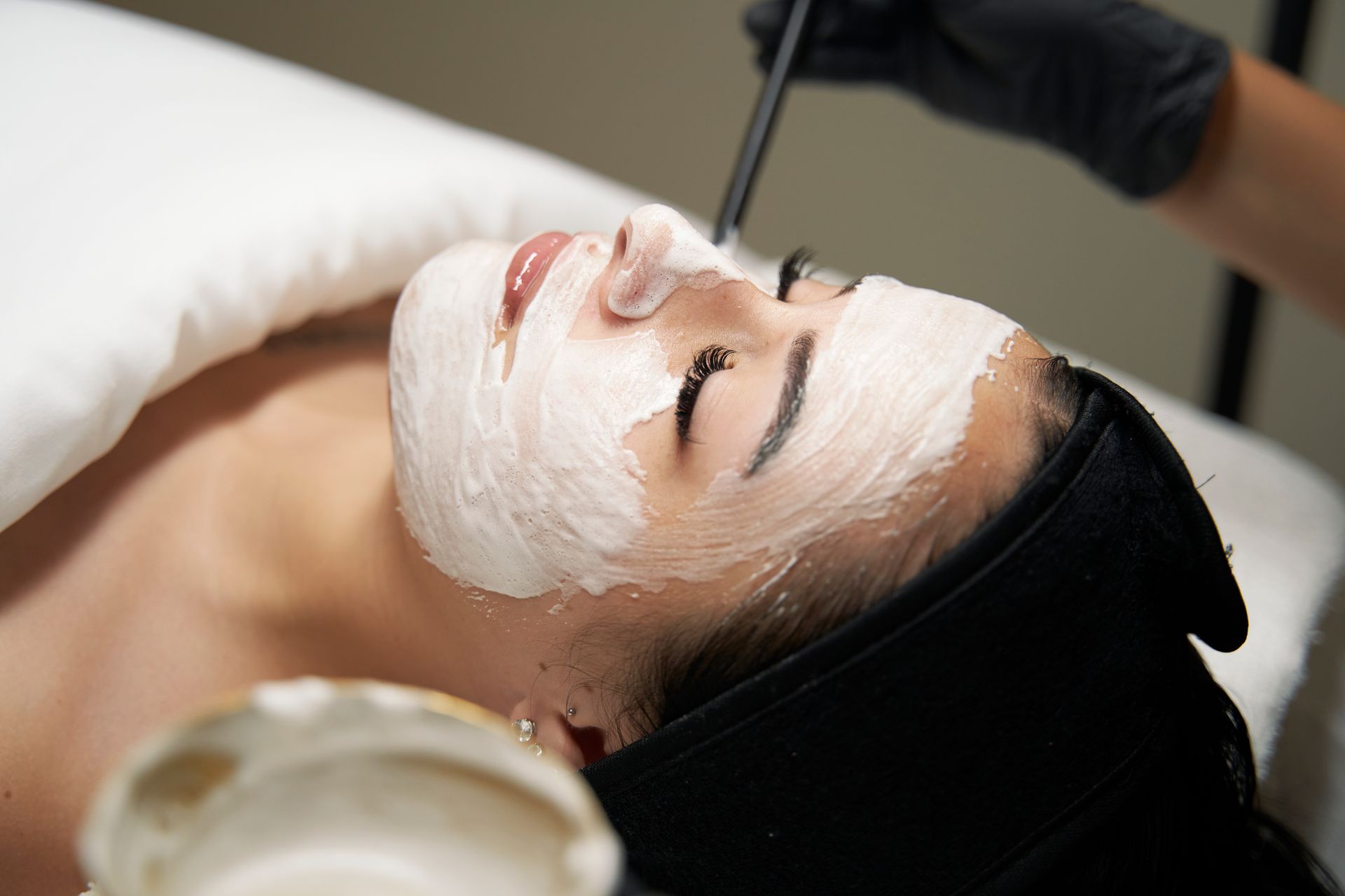 A woman is getting a facial treatment at a spa.