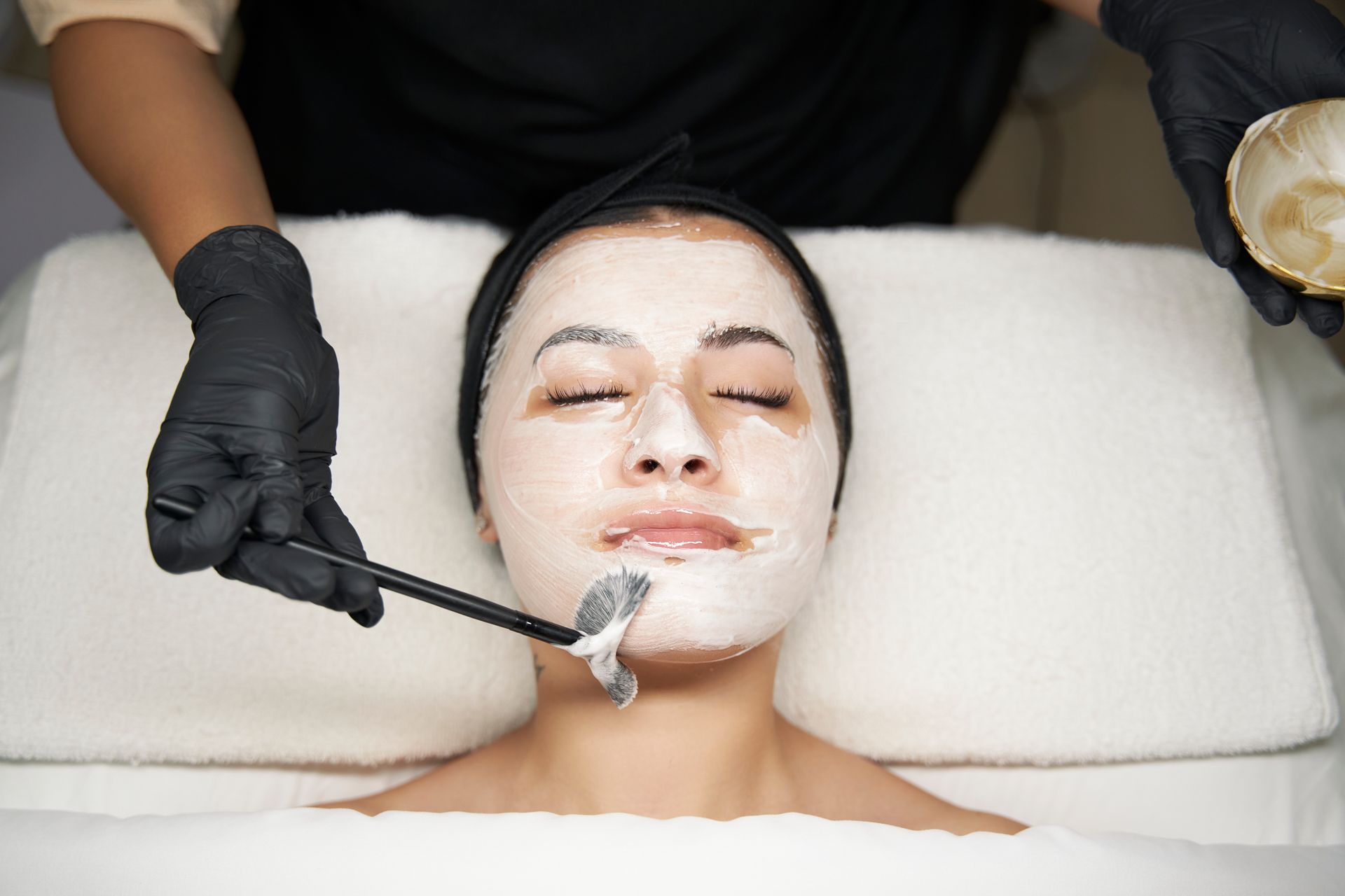 A woman is getting a facial treatment at a spa.