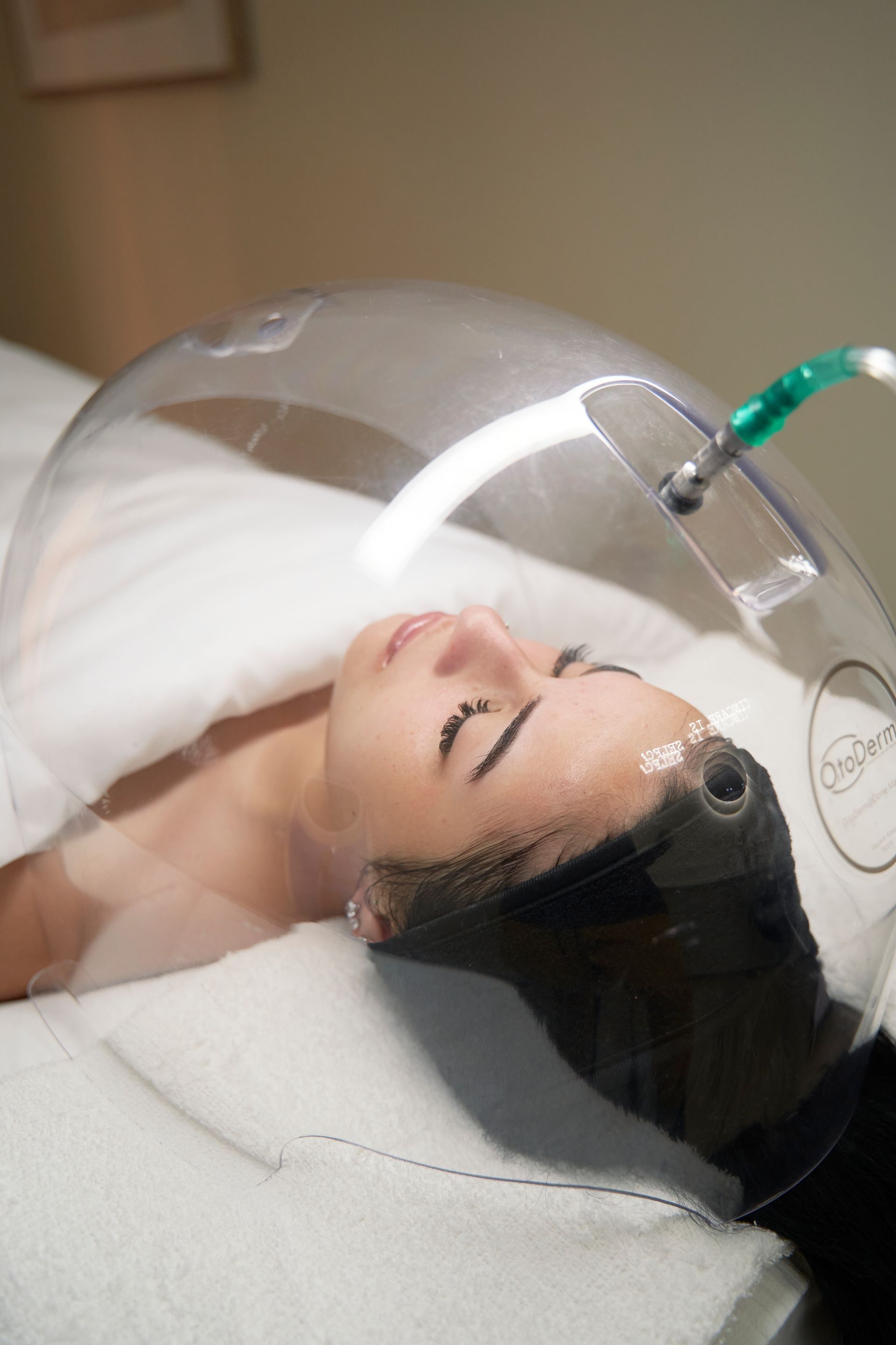 A woman is laying on a bed with a mask on her head.