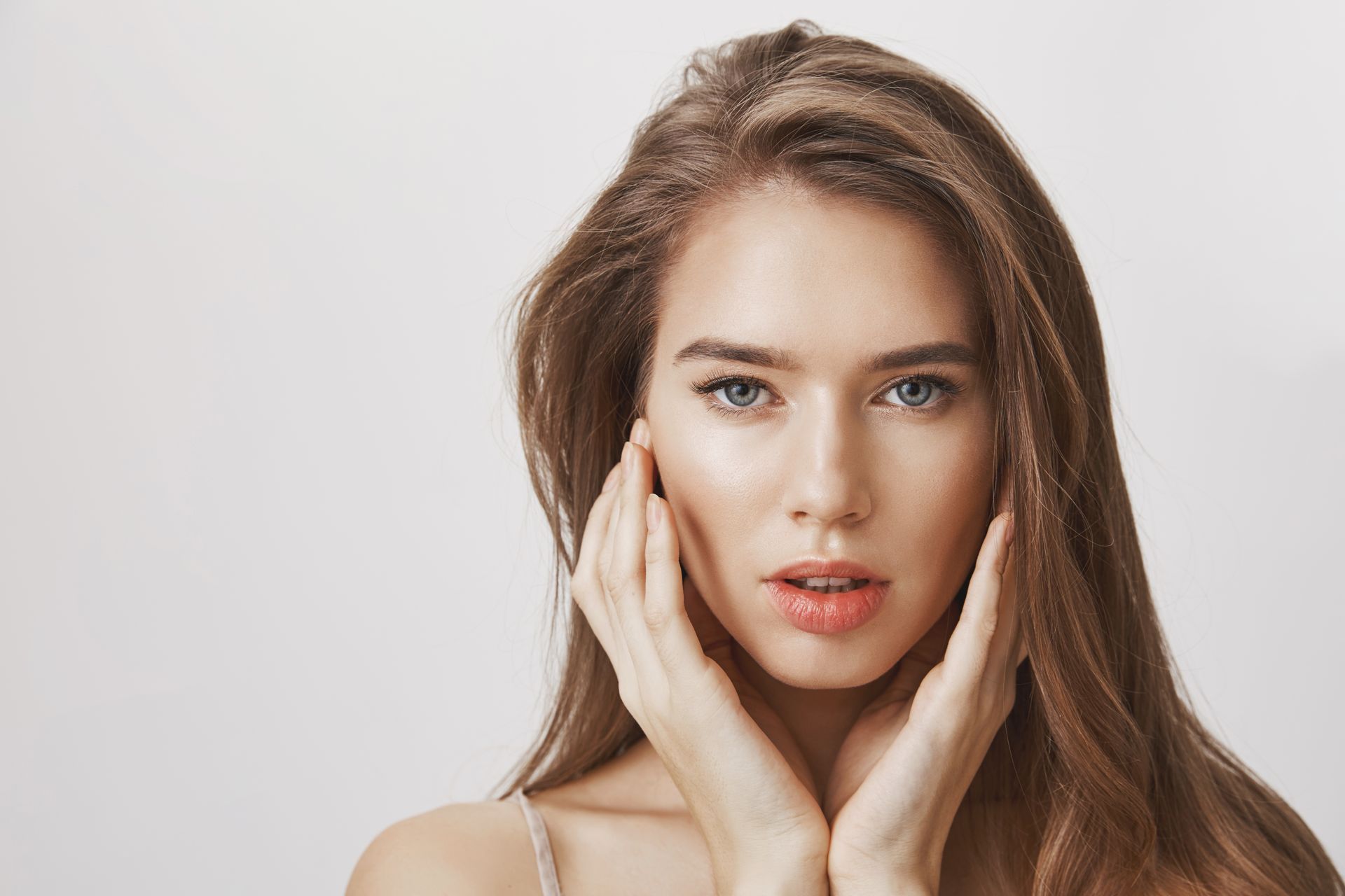 a woman touching her face.