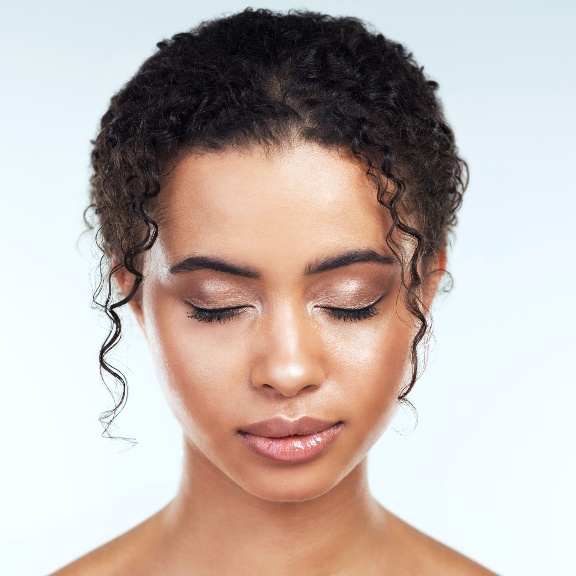 A close up of a woman 's face with her eyes closed.