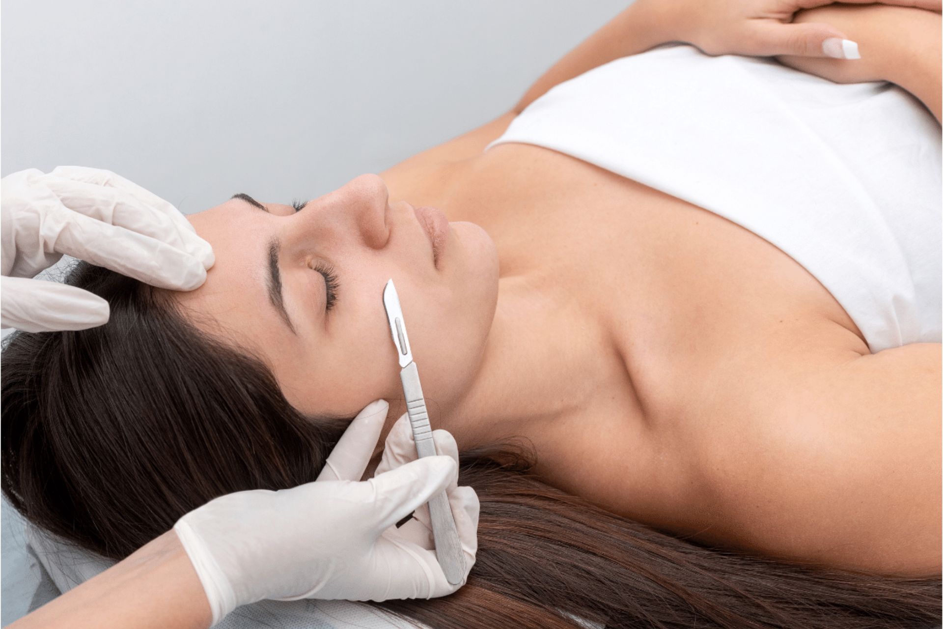 A woman is getting a botox injection in her forehead.