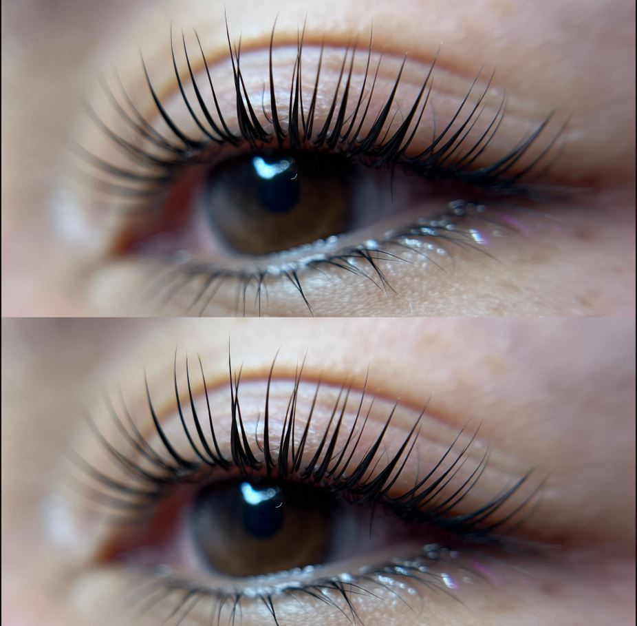 A close up of a woman 's eye with long eyelashes