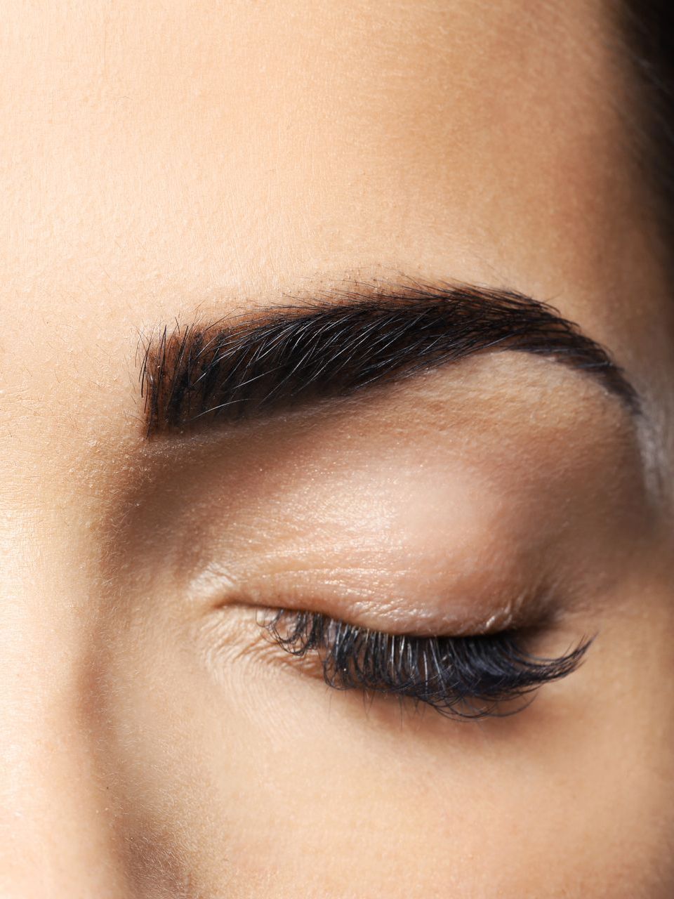 A close up of a woman 's eye with her eyes closed.
