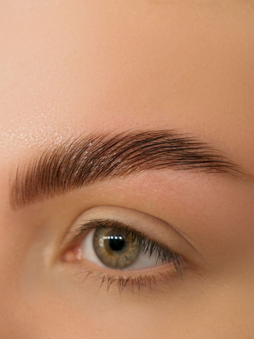 A close up of a woman 's eye and eyebrows.