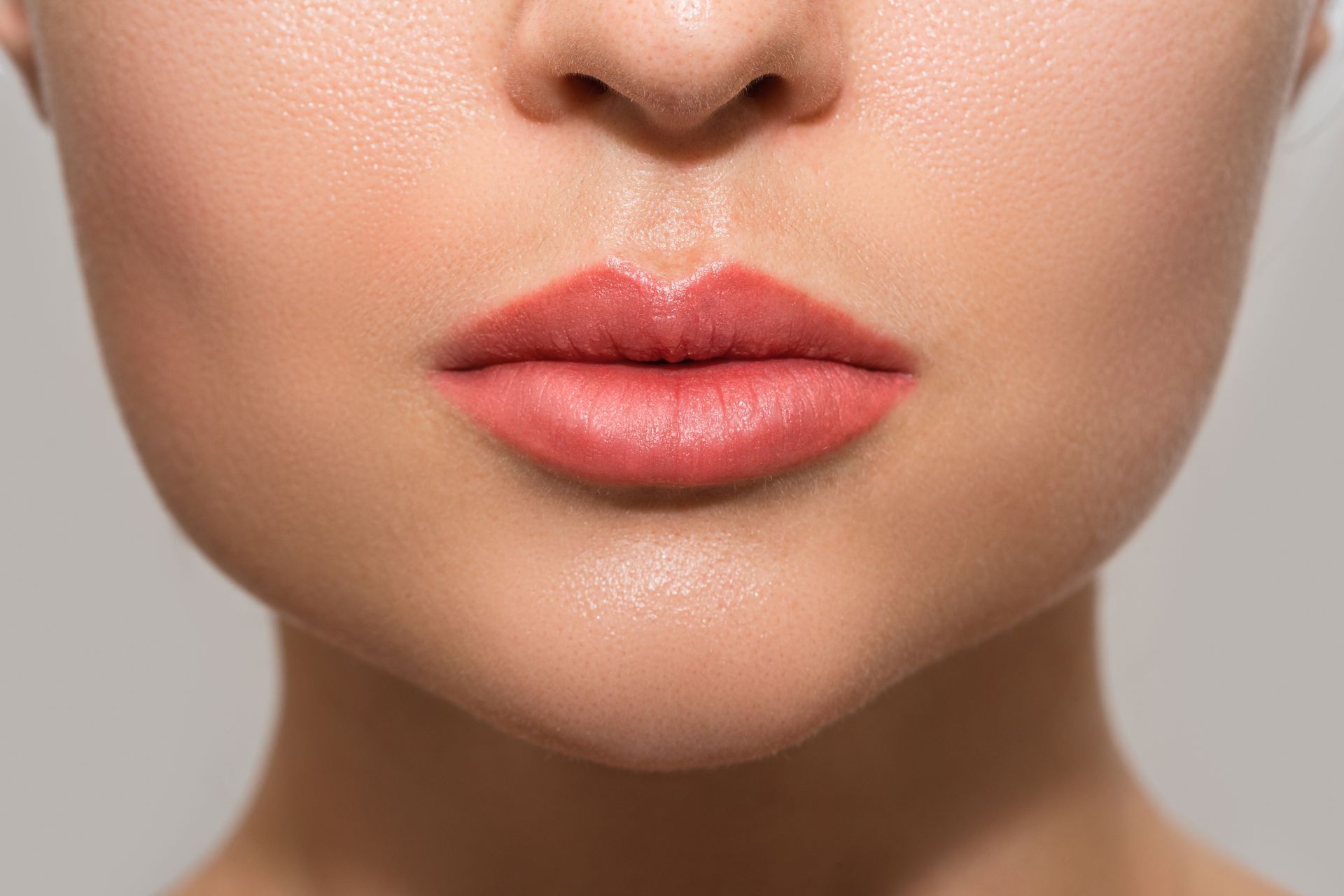 A close up of a woman 's lips with red lipstick.