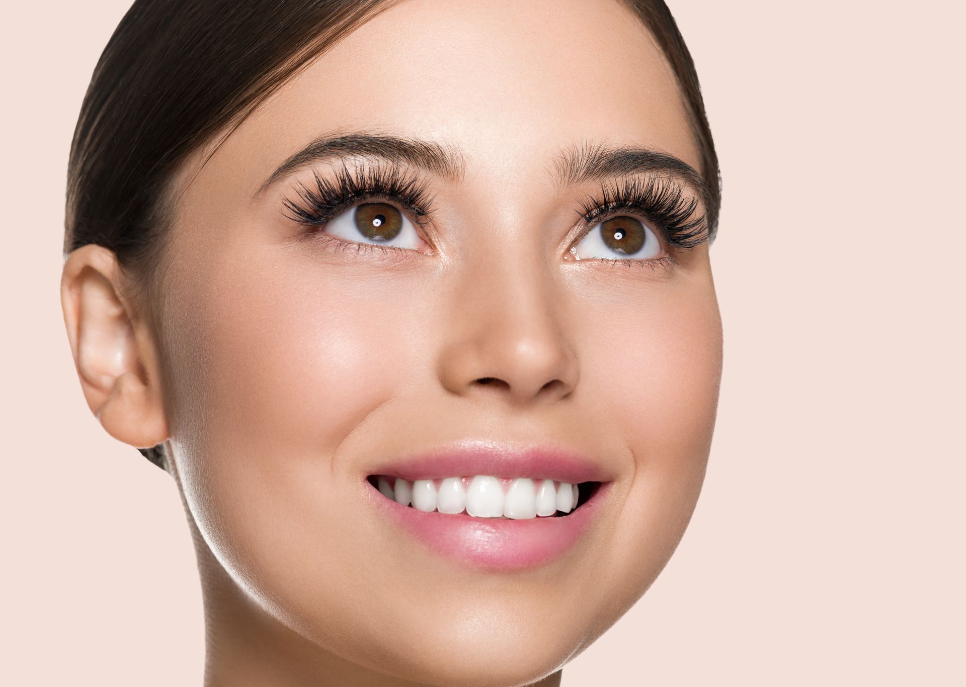 A close up of a woman 's face with a smile on her face.