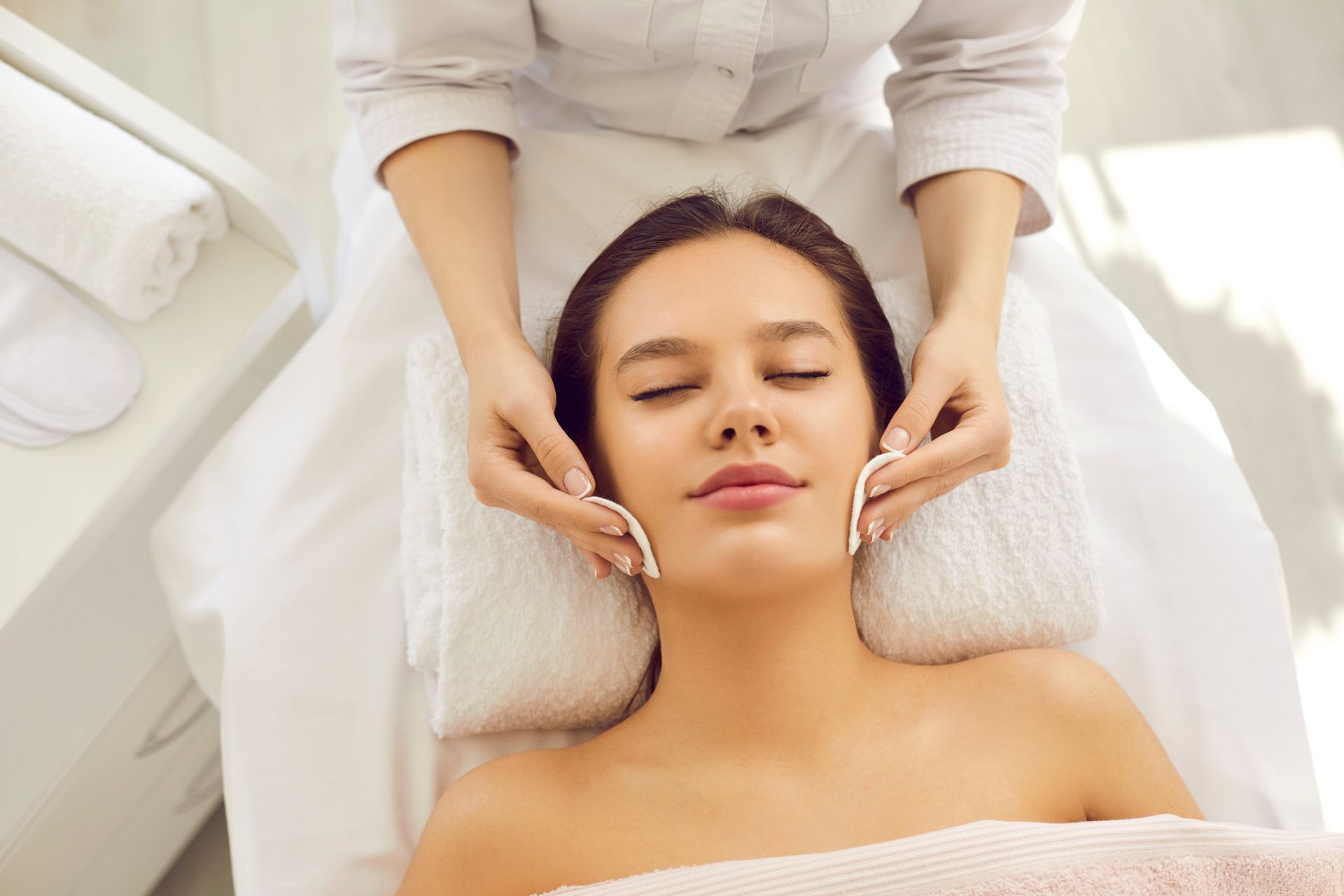 A woman is getting a facial treatment at a spa.