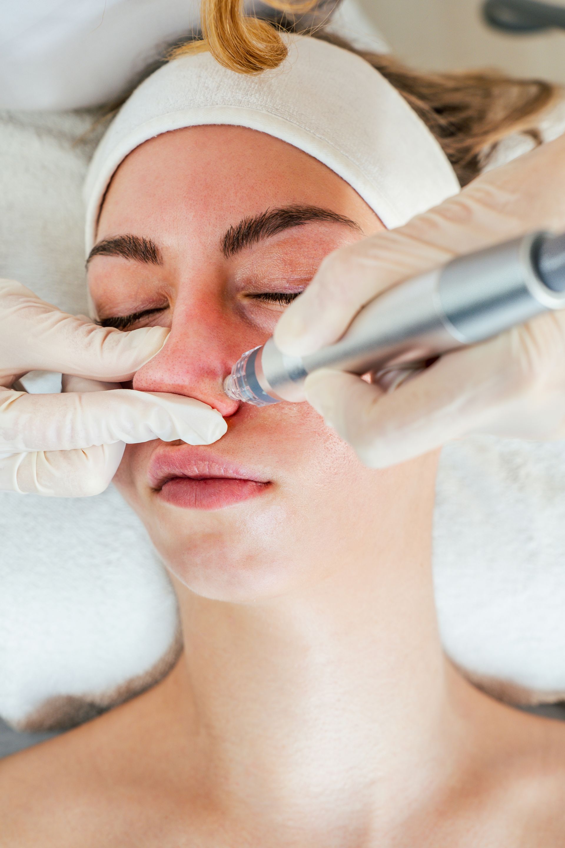 A woman is getting a facial treatment at a beauty salon.