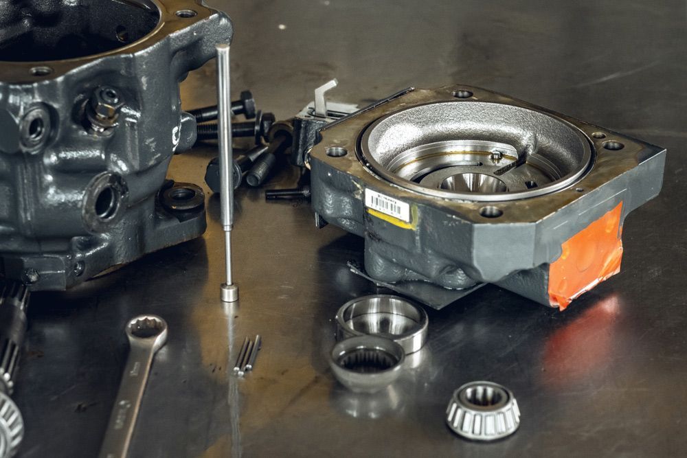 A Piece of Metal Is Sitting on A Table Next to A Wrench — Currajong Brake Parts Pty Ltd In Currajong, QLD