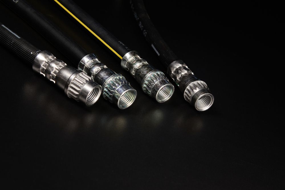 A Close Up Of Four Hose Connectors on A Black Surface — Currajong Brake Parts Pty Ltd In Currajong, QLD