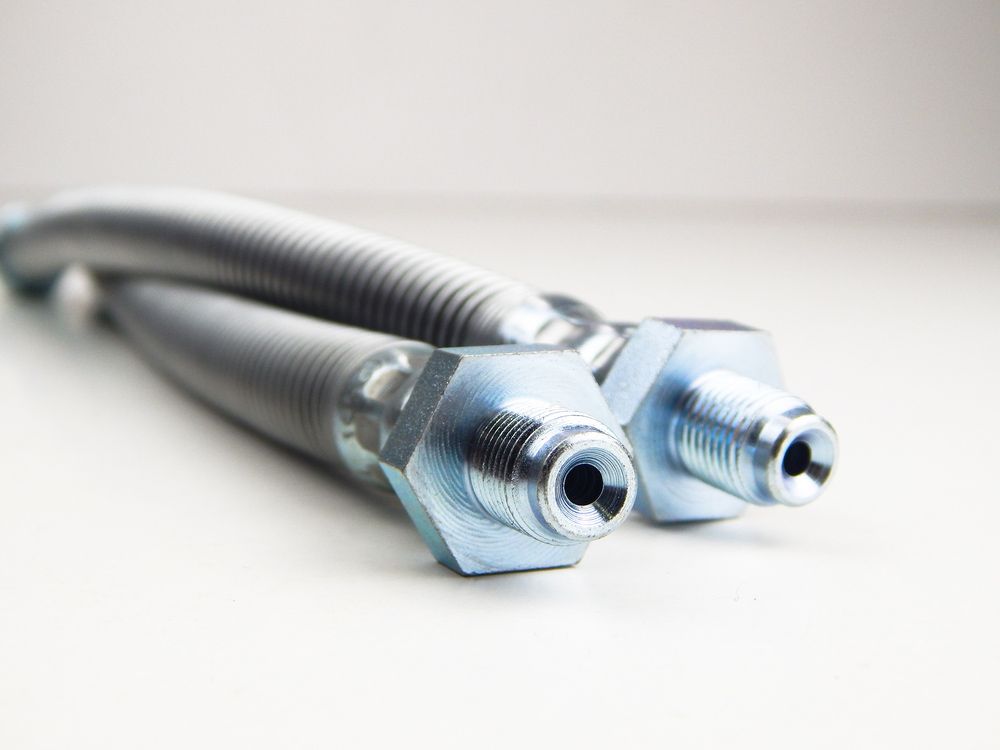 A Close Up Of Two Hose Connectors on A White Surface — Currajong Brake Parts Pty Ltd In Currajong, QLD