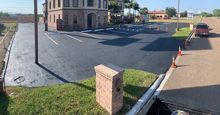 Building with a newly paved asphalt parking space — Edinburg, TX — Lone Star Asphalt Services LLC