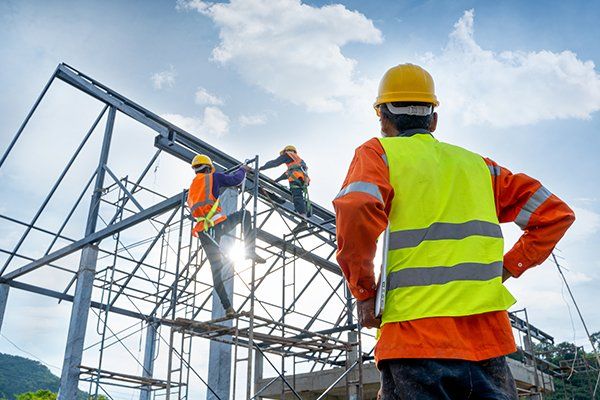 Engineer Technician Watching Team of Workers on High Steel Platform — Lansdale, PA — Gentry Builders