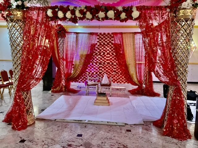 A room decorated in red and gold for a wedding