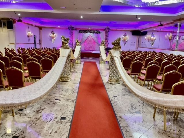 A large room with rows of chairs and a red carpet